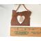Photo of Copper I Love Oregon Ornament with Heart shape cutout in the middle and an Oregon Sunstone gemstone hanging inside the heart cutout, shown next to ruler for size reference